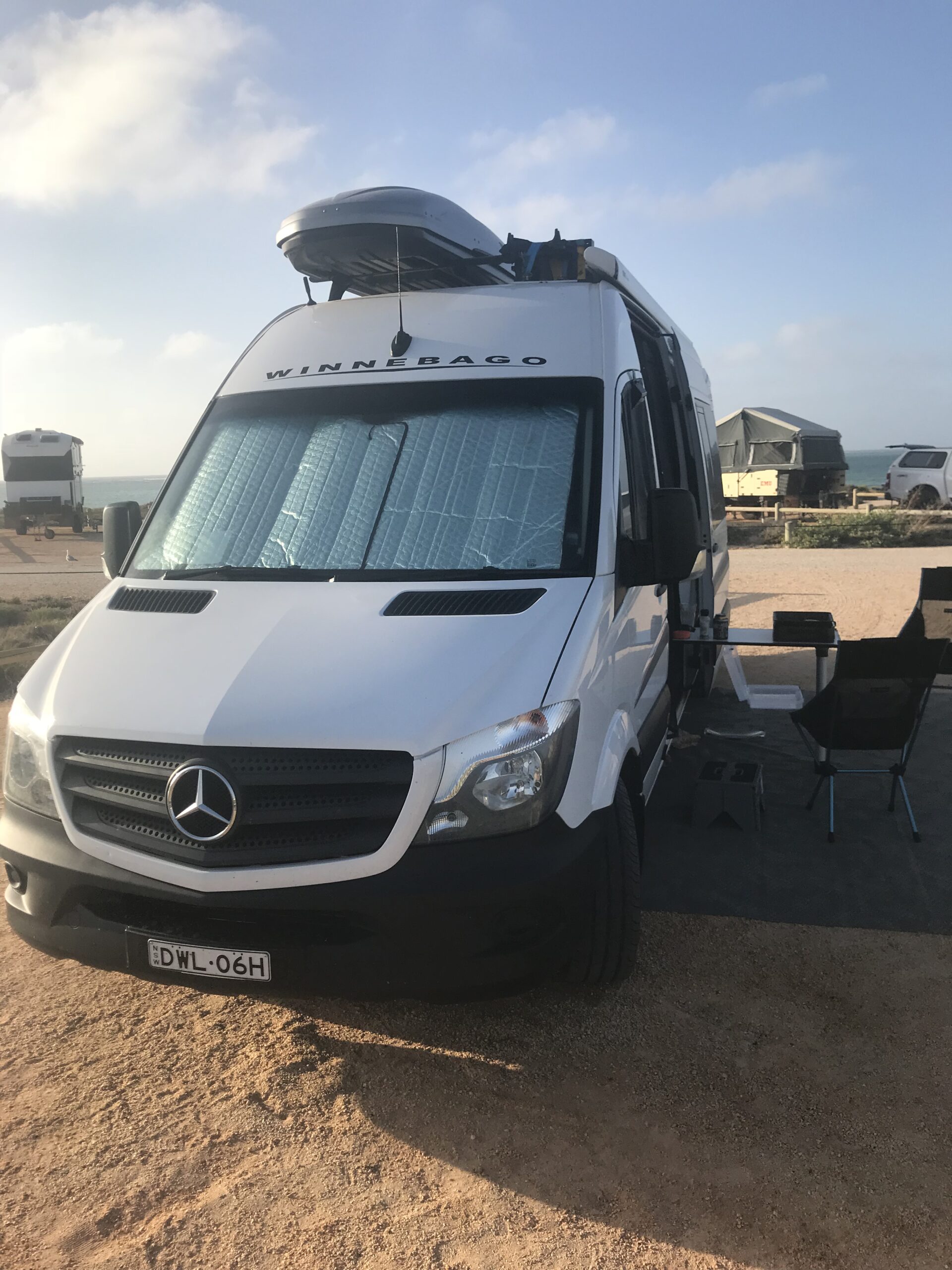 Van with awning at camp